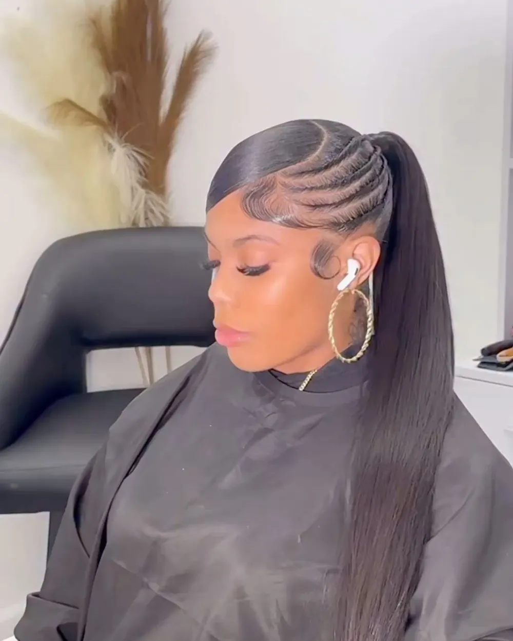 Woman with a sleek side-part braided ponytail